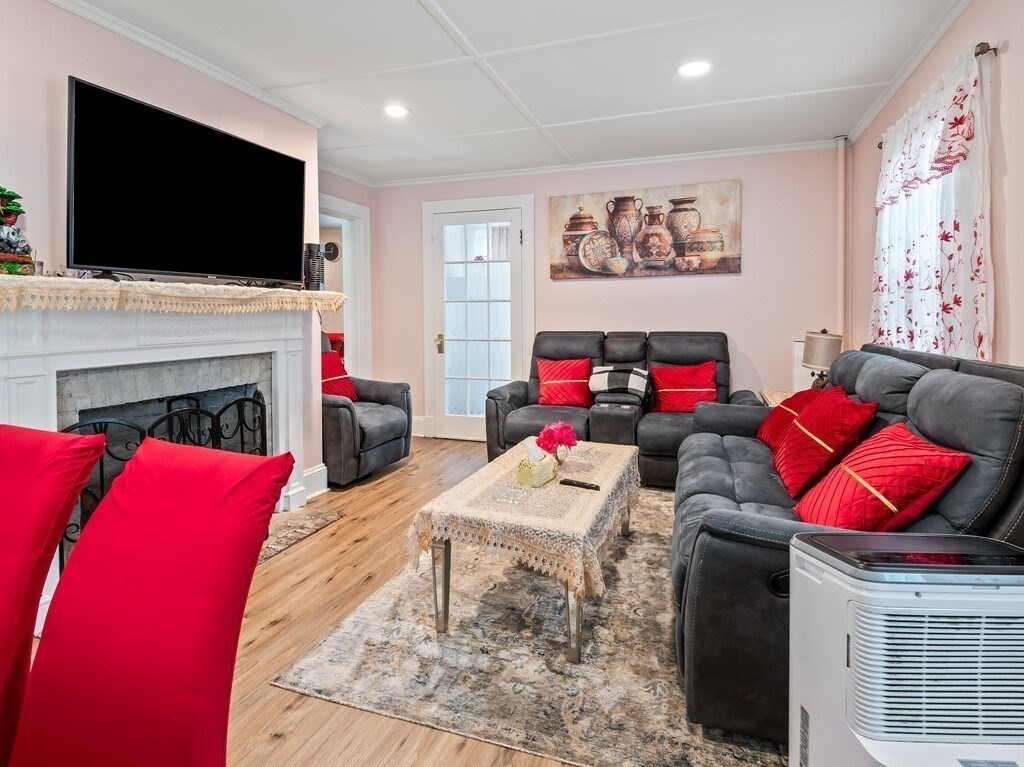 28 Maple Street Southbridge, MA 01550 - Photo 2 of 36 a living room with furniture and a flat screen tv