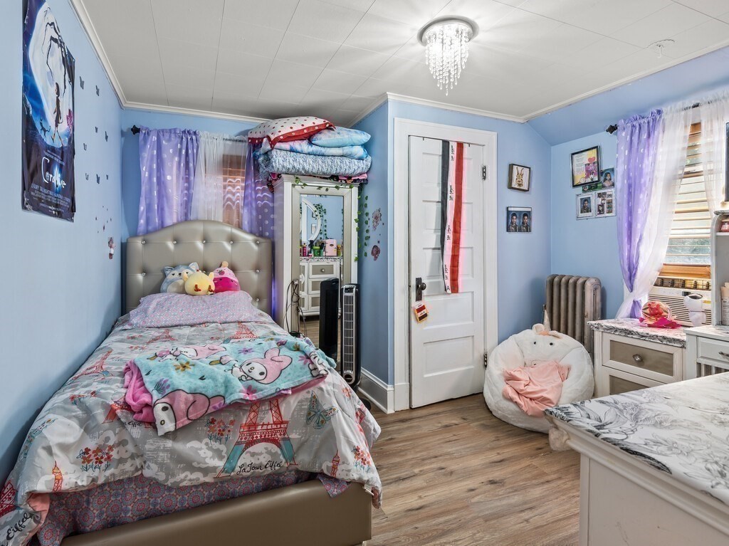 28 Maple Street Southbridge, MA 01550 - Photo 23 of 36 a bedroom with bed and wooden floor