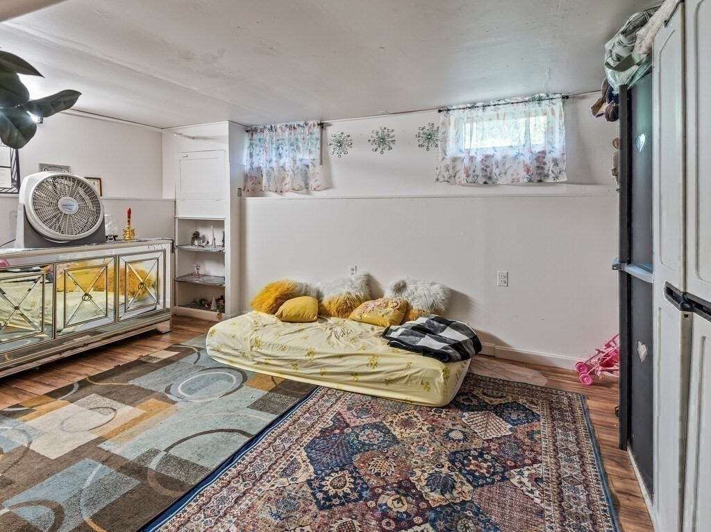 28 Maple Street Southbridge, MA 01550 - Photo 29 of 36 a bedroom with a bed and a chandelier