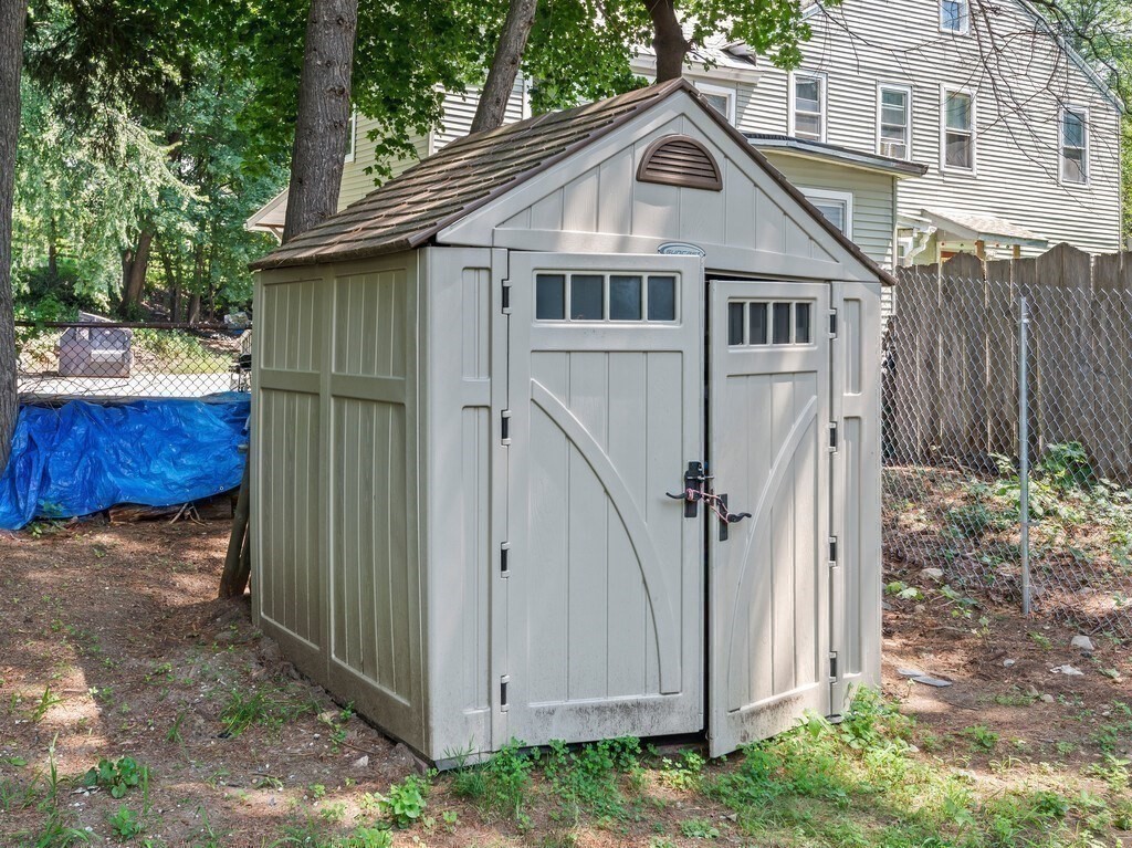 28 Maple Street Southbridge, MA 01550 - Photo 34 of 36 a view of a small white house with a small yard and large tree