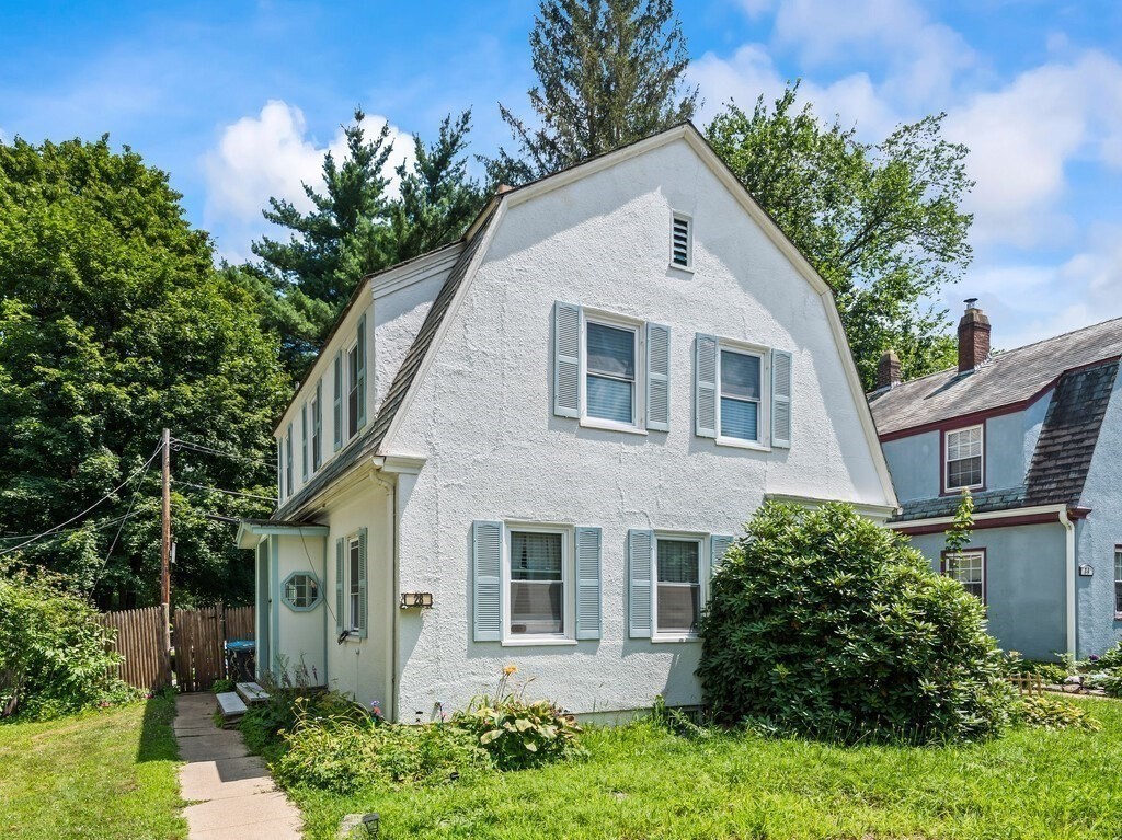 28 Maple Street Southbridge, MA 01550 - Photo 4 of 36 a front view of a house with a garden