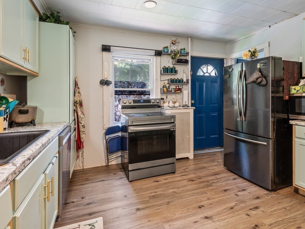 28 Maple Street Southbridge, MA 01550 - Photo 8 of 36 a kitchen with a stove top oven and refrigerator