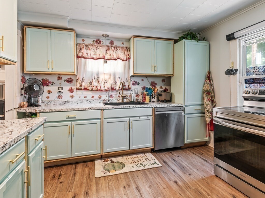 28 Maple Street Southbridge, MA 01550 - Photo 10 of 36 a kitchen with a sink stove and cabinets