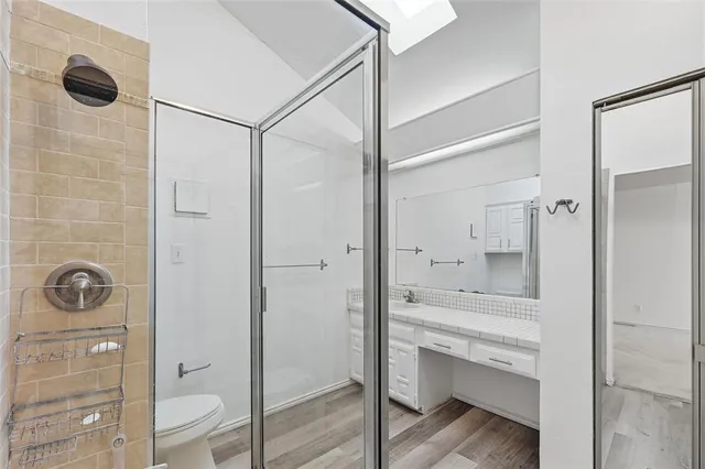 a bathroom with a shower sink and mirror