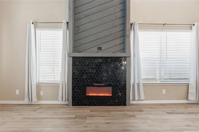 a view of fireplace and wooden floor