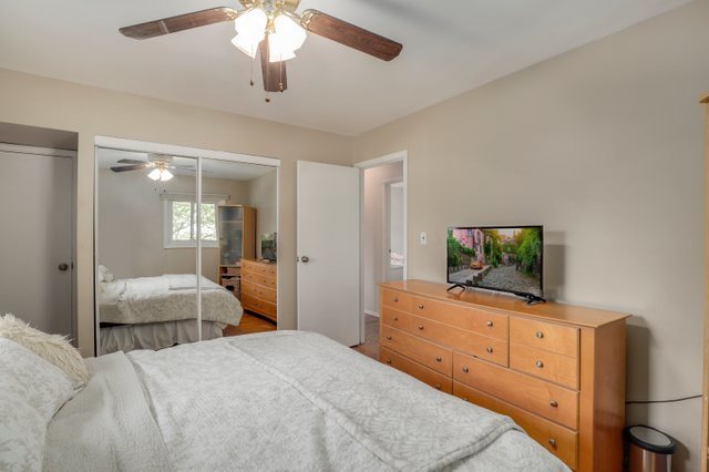 21W120 Everest Road Lombard, IL 60148 - Photo 14 of 33 a bedroom with chandelier and flat screen tv