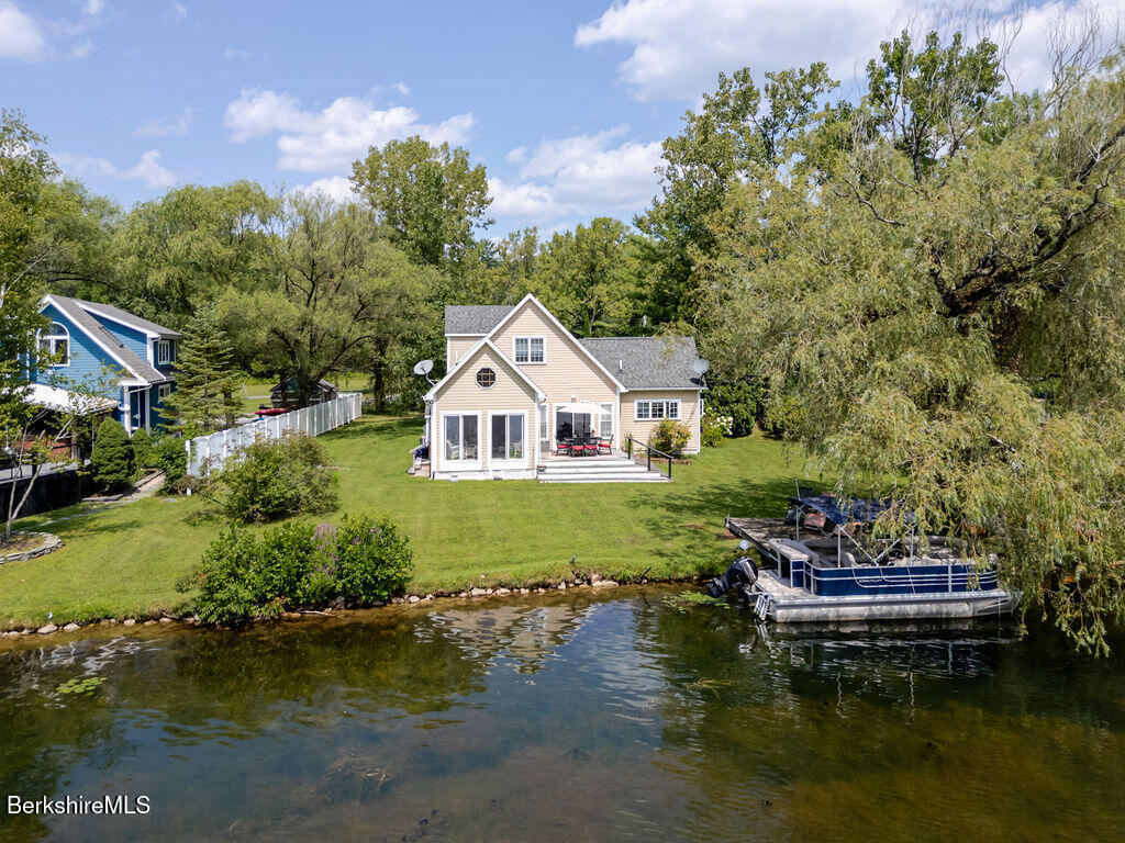 16 Heberts Cove Monterey, MA 01230 - Photo 1 of 47 a aerial view of a house with swimming pool and a yard
