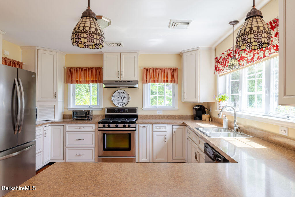 16 Heberts Cove Monterey, MA 01230 - Photo 19 of 47 a kitchen with a stove a refrigerator and a sink