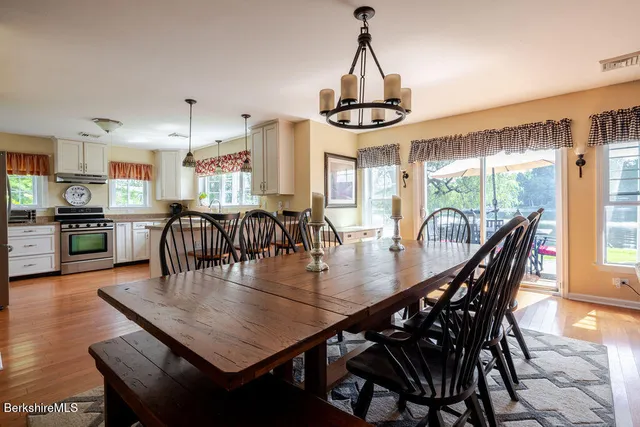 a dining room with furniture window and wooden floor