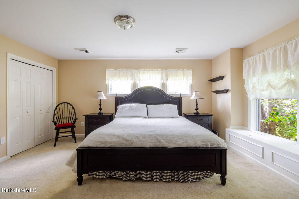 16 Heberts Cove Monterey, MA 01230 - Photo 24 of 47 a bedroom with a bed chair and window