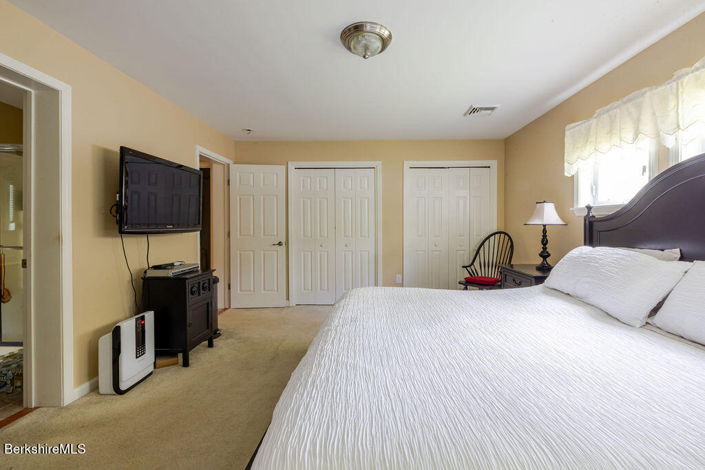 16 Heberts Cove Monterey, MA 01230 - Photo 26 of 47 a bedroom with a bed and a television in it