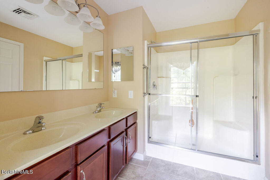 16 Heberts Cove Monterey, MA 01230 - Photo 27 of 47 a bathroom with a granite countertop sink mirror and a shower