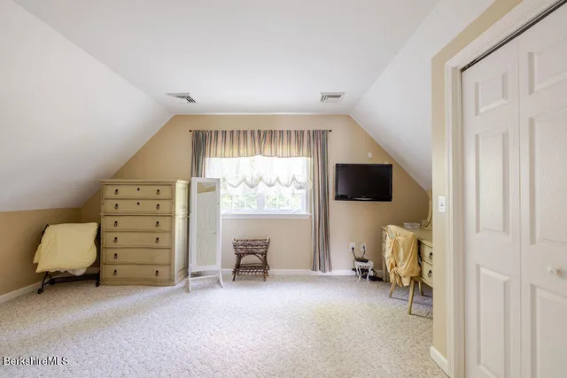 a view of a livingroom with furniture and a window