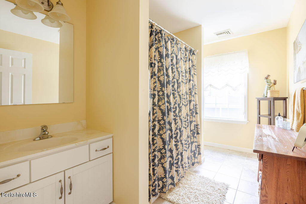 16 Heberts Cove Monterey, MA 01230 - Photo 31 of 47 a bathroom with a shower curtain and a sink