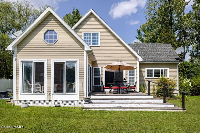 a view of house and a yard with swimming pool