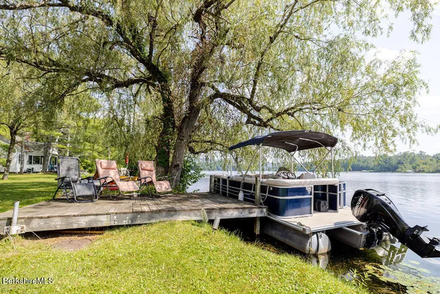 a view of swimming pool with outdoor seating and trees