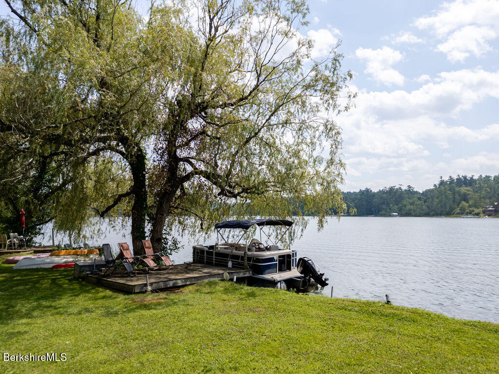 16 Heberts Cove Monterey, MA 01230 - Photo 41 of 47 a view of a lake with lawn chairs and a large tree