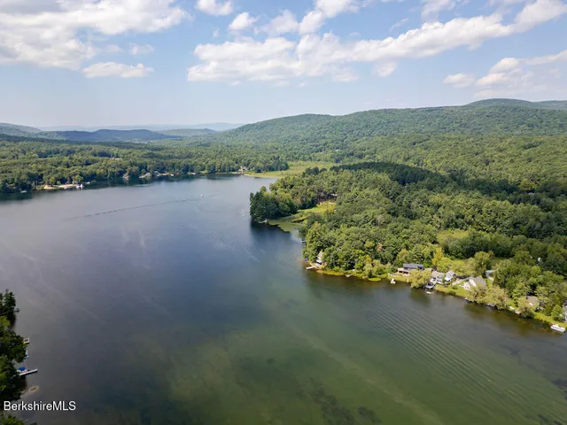 an aerial view of a houses with ocean view