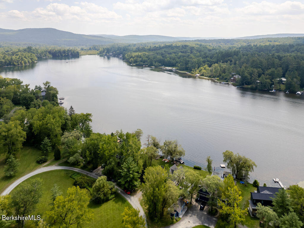 16 Heberts Cove Monterey, MA 01230 - Photo 6 of 47 an aerial view of green landscape with trees houses and lake view