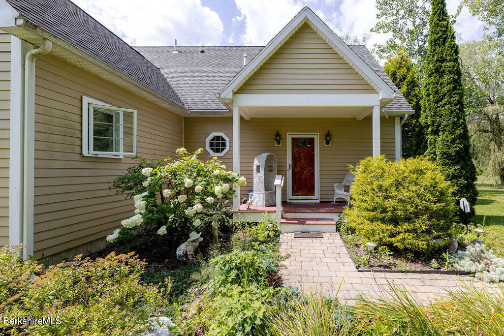 16 Heberts Cove Monterey, MA 01230 - Photo 7 of 47 a front view of a house with a yard