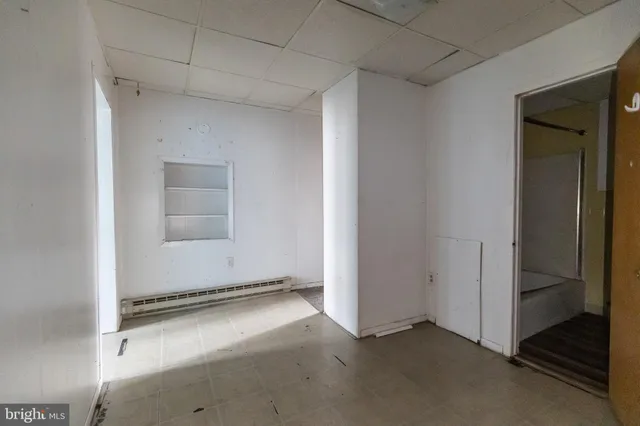 a white toilet sitting next to a bathroom sink and a shower