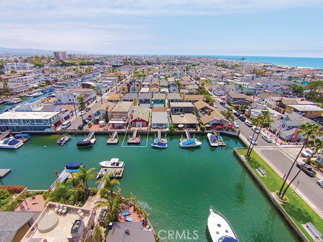 an aerial view of a city with lots of residential buildings and mountain view in back