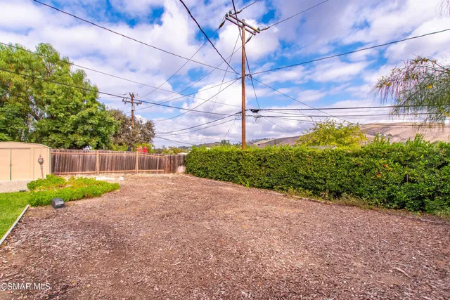 a view of a house with a yard and potted plants