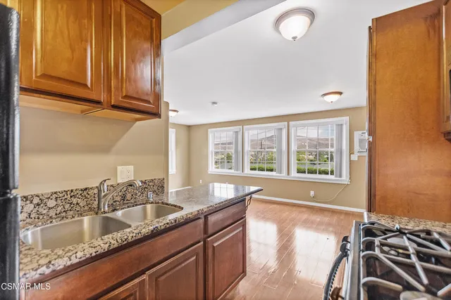 a kitchen with granite countertop a sink and a stove