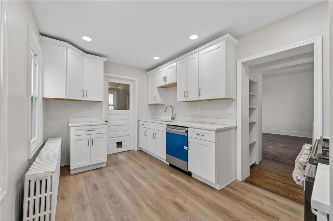 65 2nd Street Slatington, PA 18080 - Photo 19 of 46 A well-appointed kitchen showcasing contemporary white cabinetry and light wood flooring.