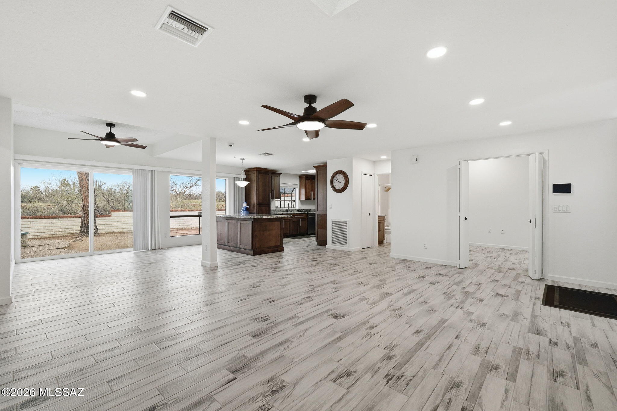 1183 Circulo Canario Rio Rico, AZ 85648 - Photo 1 of 31 an empty room with wooden floor and a ceiling fan