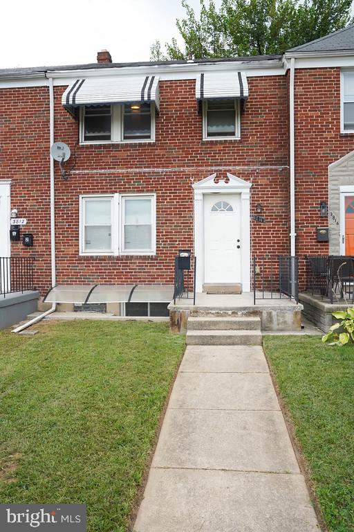 3814 Erdman Avenue Baltimore, MD 21213 - Photo 1 of 18 a front view of a house with a garden