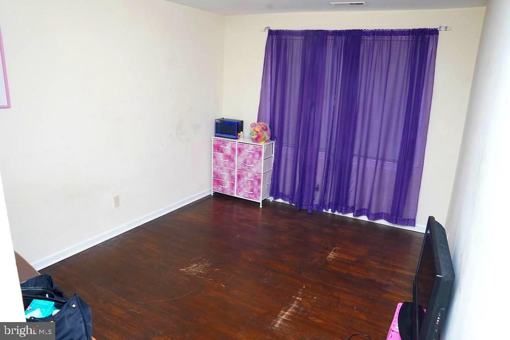 3814 Erdman Avenue Baltimore, MD 21213 - Photo 11 of 18 a view of a room with a wooden wall