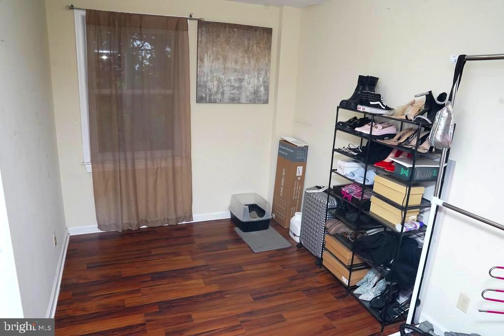 3814 Erdman Avenue Baltimore, MD 21213 - Photo 12 of 18 a view of a hallway with wooden floor and furniture