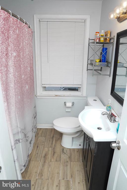 3814 Erdman Avenue Baltimore, MD 21213 - Photo 13 of 18 a bathroom with a sink a toilet and a mirror
