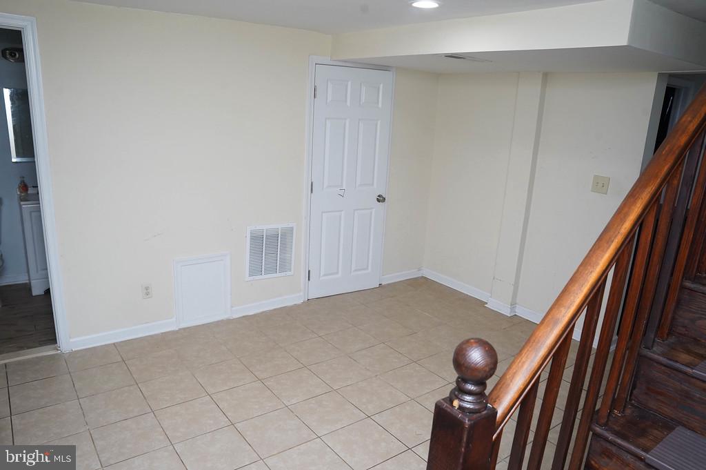 3814 Erdman Avenue Baltimore, MD 21213 - Photo 16 of 18 a view of an empty room with wooden floor