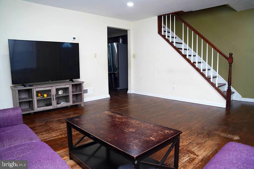 3814 Erdman Avenue Baltimore, MD 21213 - Photo 4 of 18 a living room with furniture and a flat screen tv