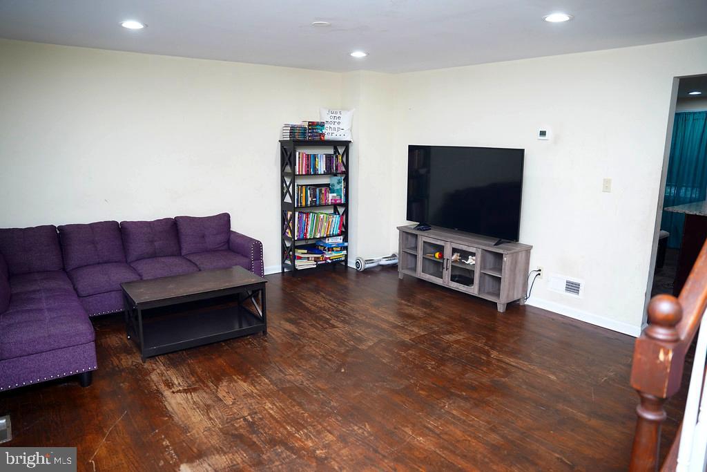 3814 Erdman Avenue Baltimore, MD 21213 - Photo 5 of 18 a living room with furniture and a flat screen tv