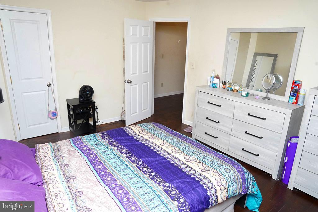 3814 Erdman Avenue Baltimore, MD 21213 - Photo 8 of 18 a bedroom with a bed and a mirror