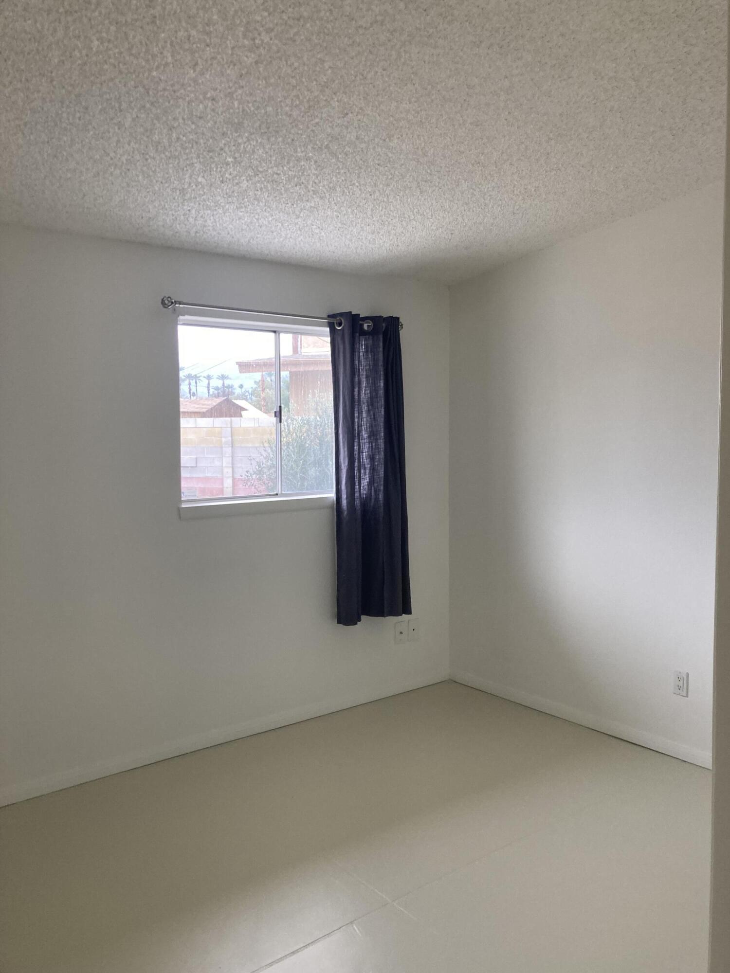 74091 Aster Drive Palm Desert, CA 92260 - Photo 11 of 16 an empty room with windows