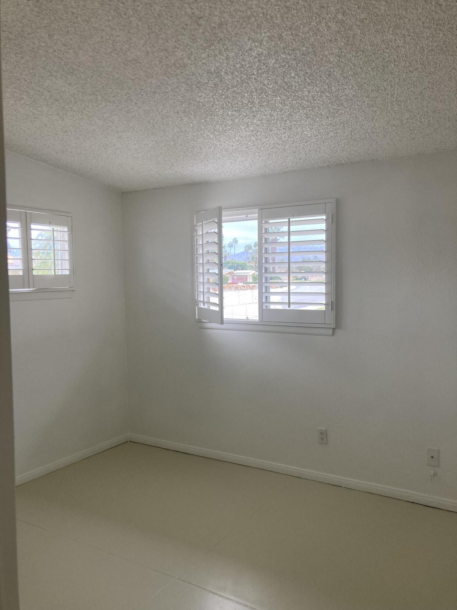 74091 Aster Drive Palm Desert, CA 92260 - Photo 12 of 16 an empty room with a window