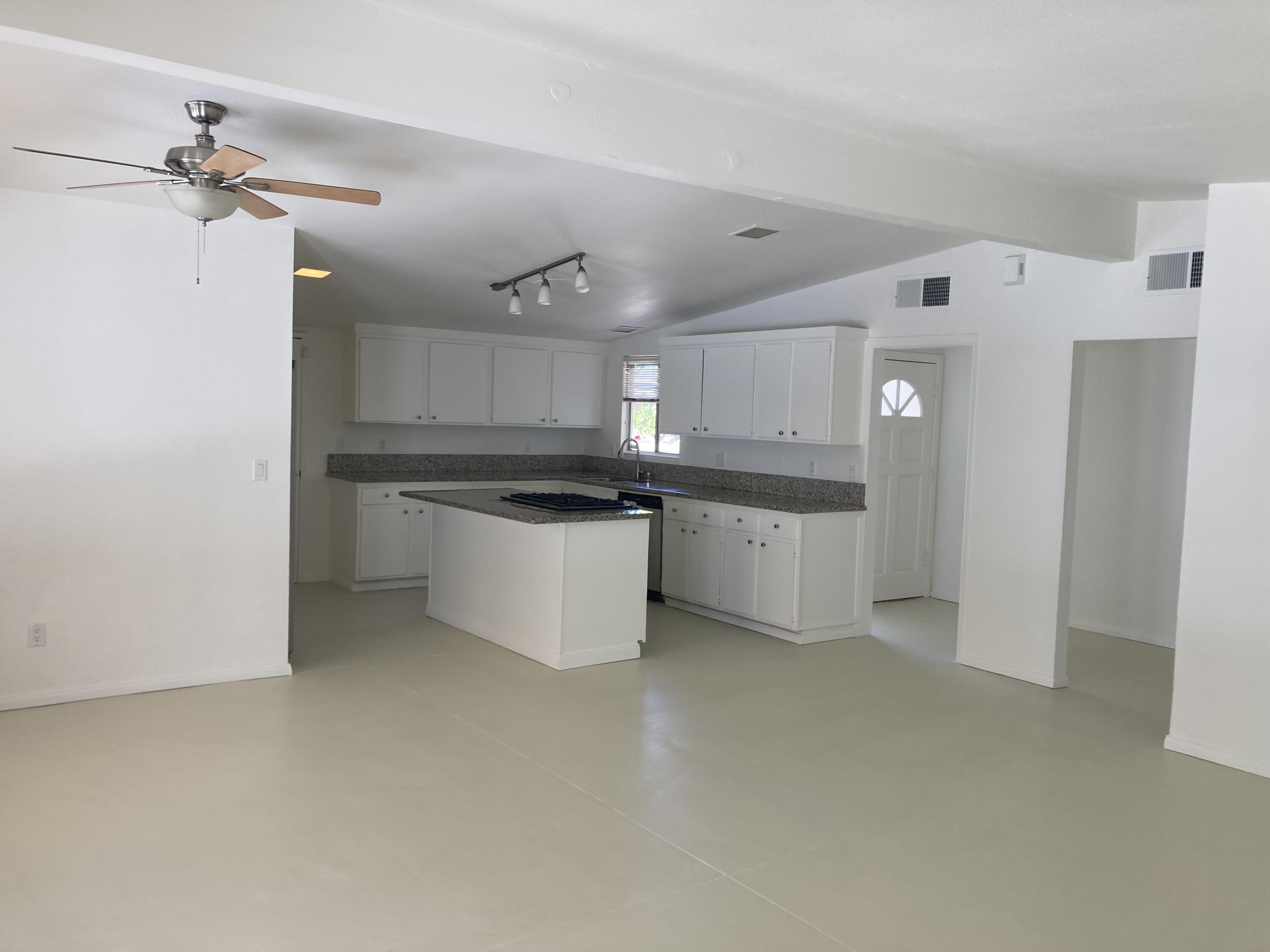 74091 Aster Drive Palm Desert, CA 92260 - Photo 4 of 16 a kitchen with stainless steel appliances a refrigerator sink and cabinets