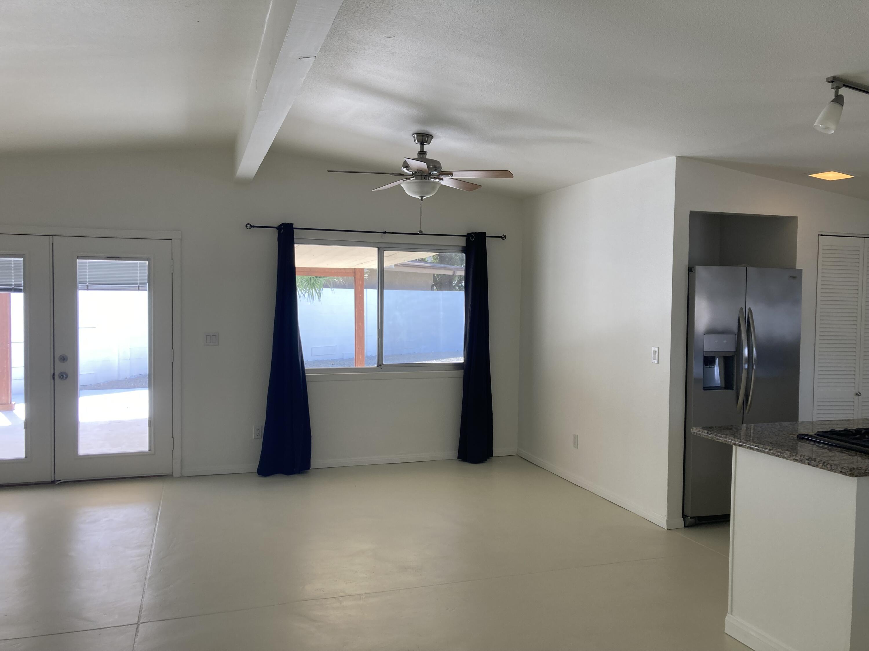 74091 Aster Drive Palm Desert, CA 92260 - Photo 6 of 16 wooden floor in an empty room with a window