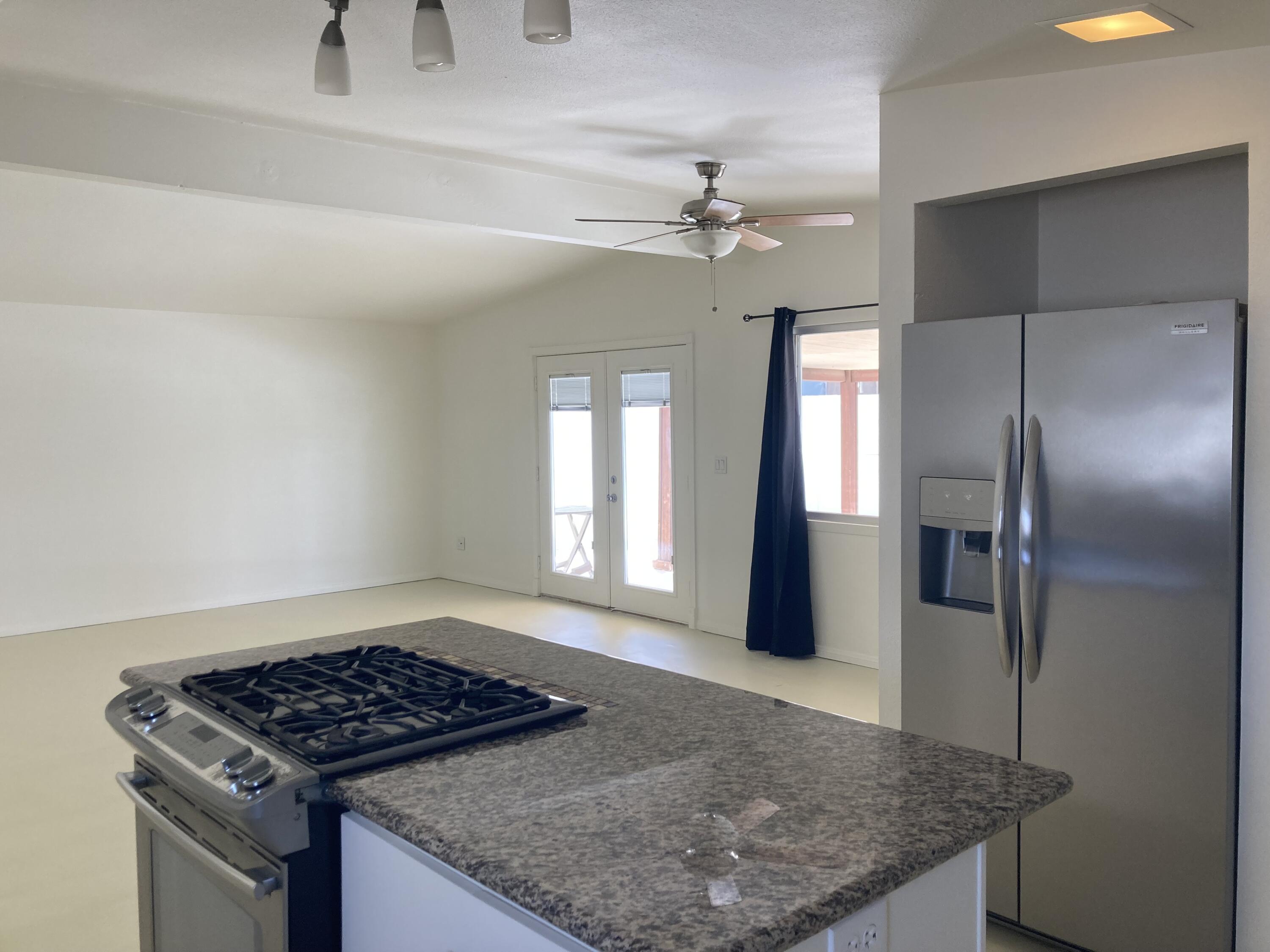 74091 Aster Drive Palm Desert, CA 92260 - Photo 7 of 16 an open kitchen with granite countertop stove and refrigerator
