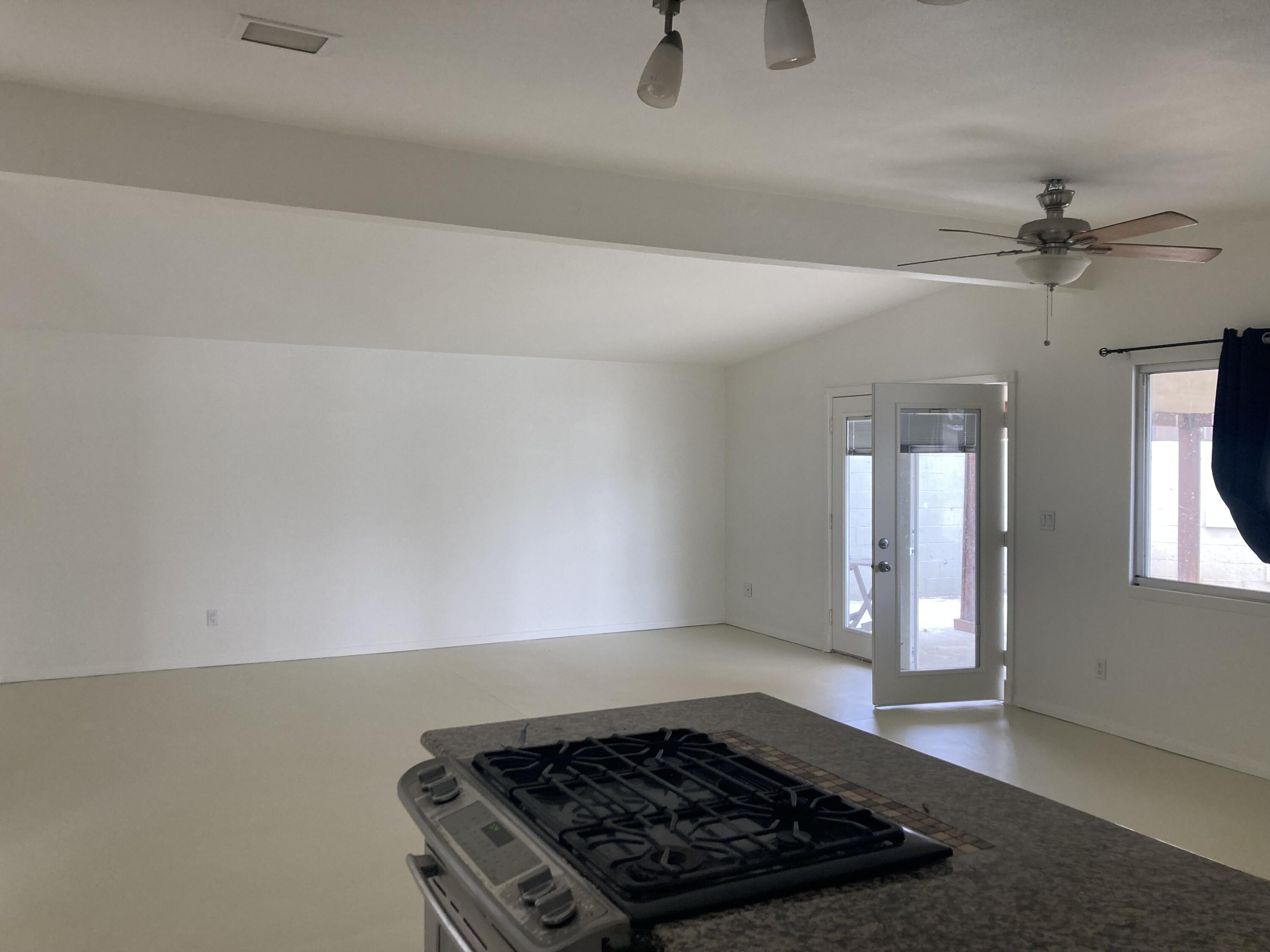 74091 Aster Drive Palm Desert, CA 92260 - Photo 8 of 16 a close view of a stove a microwave and cabinets