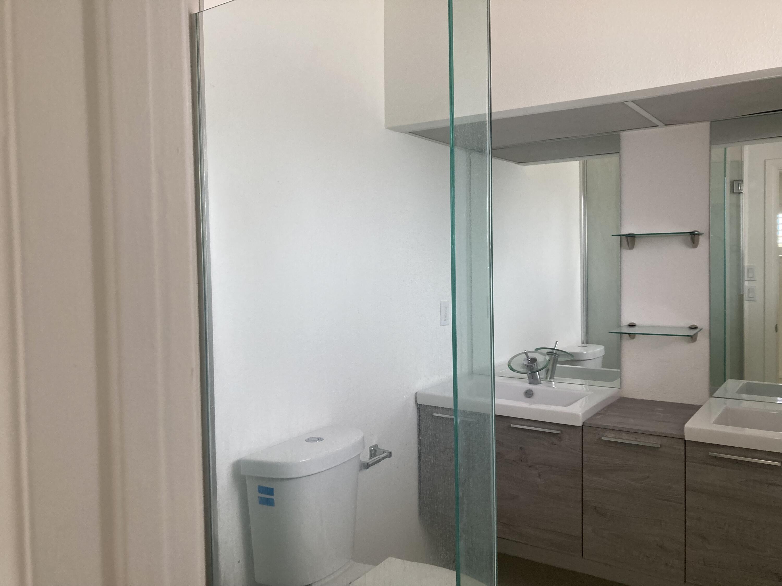 74091 Aster Drive Palm Desert, CA 92260 - Photo 10 of 16 a bathroom with a sink and mirror with toilet