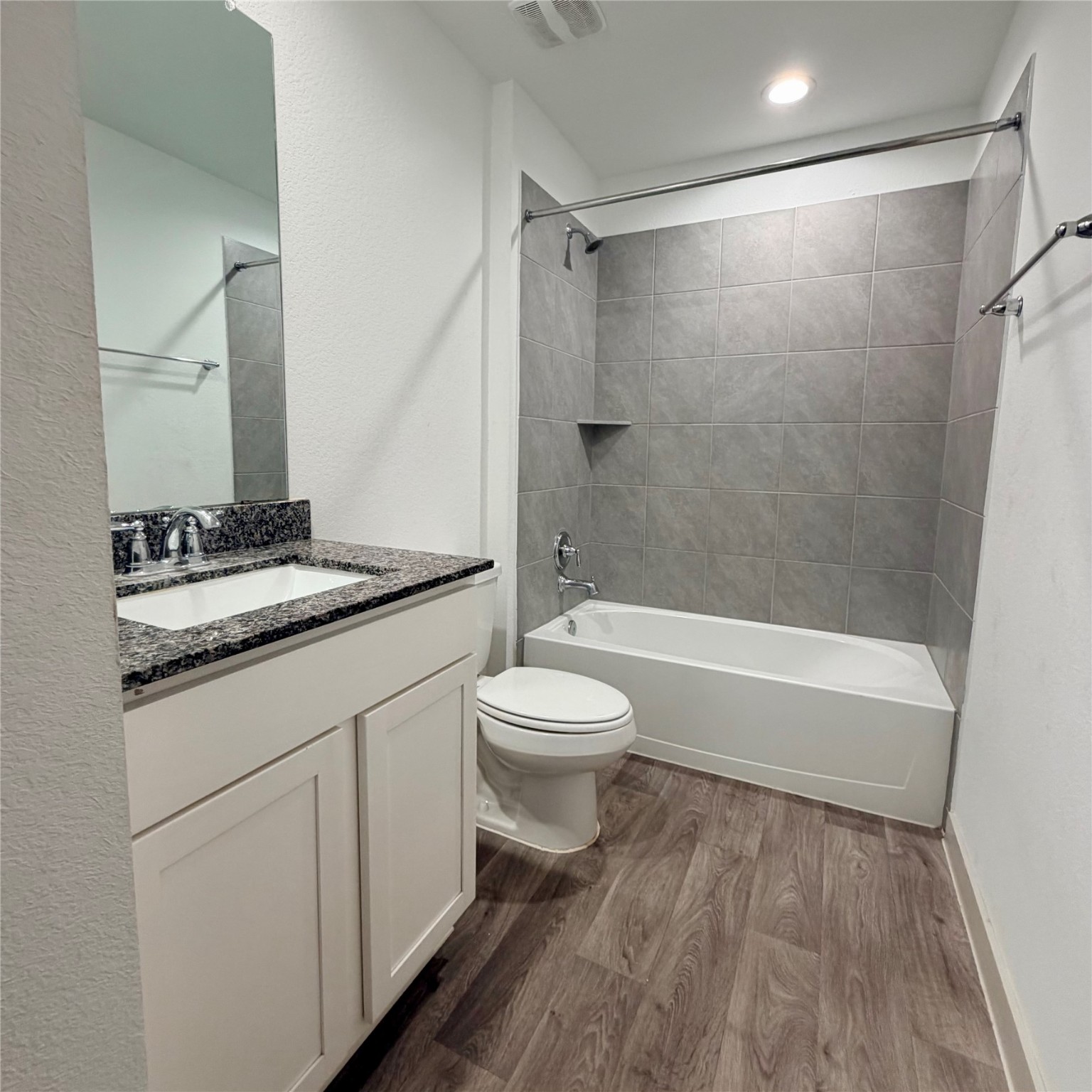 10610 Great Basin Drive Rosharon, TX 77583 - Photo 10 of 14 a bathroom with a granite countertop sink toilet a mirror and shower