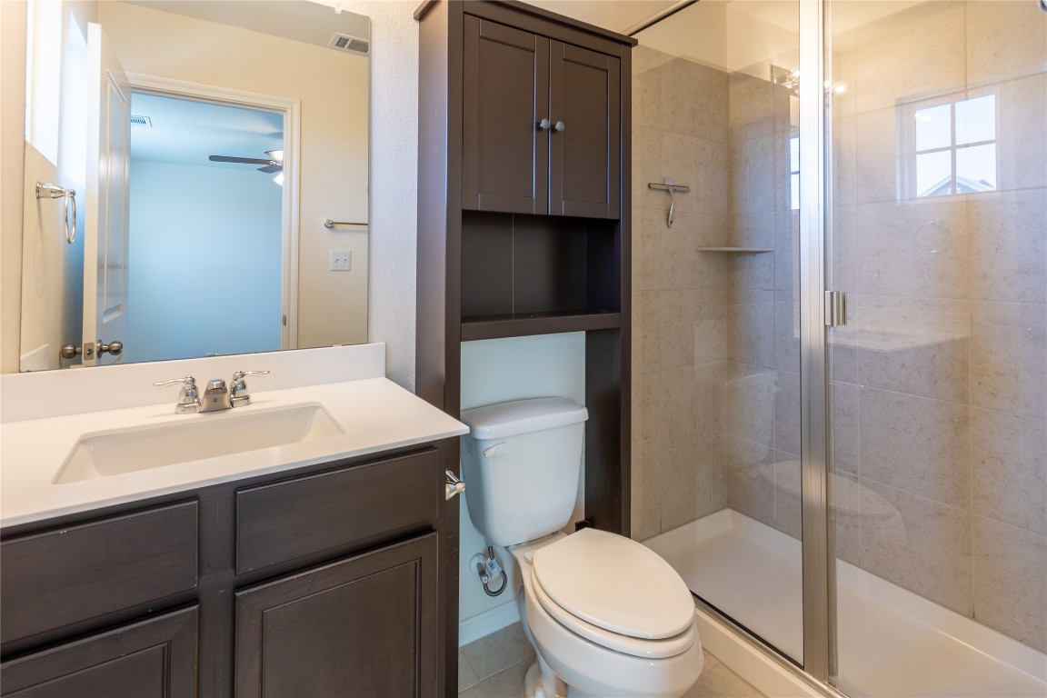 17927 Papaveri Way Pflugerville, TX 78660 - Photo 20 of 26 a bathroom with a sink toilet vanity and shower
