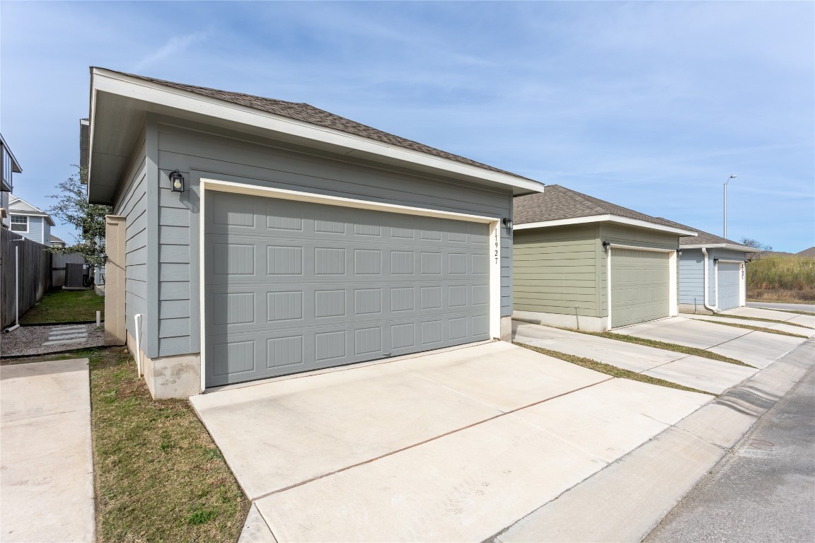 17927 Papaveri Way Pflugerville, TX 78660 - Photo 23 of 26 Garage featuring driveway