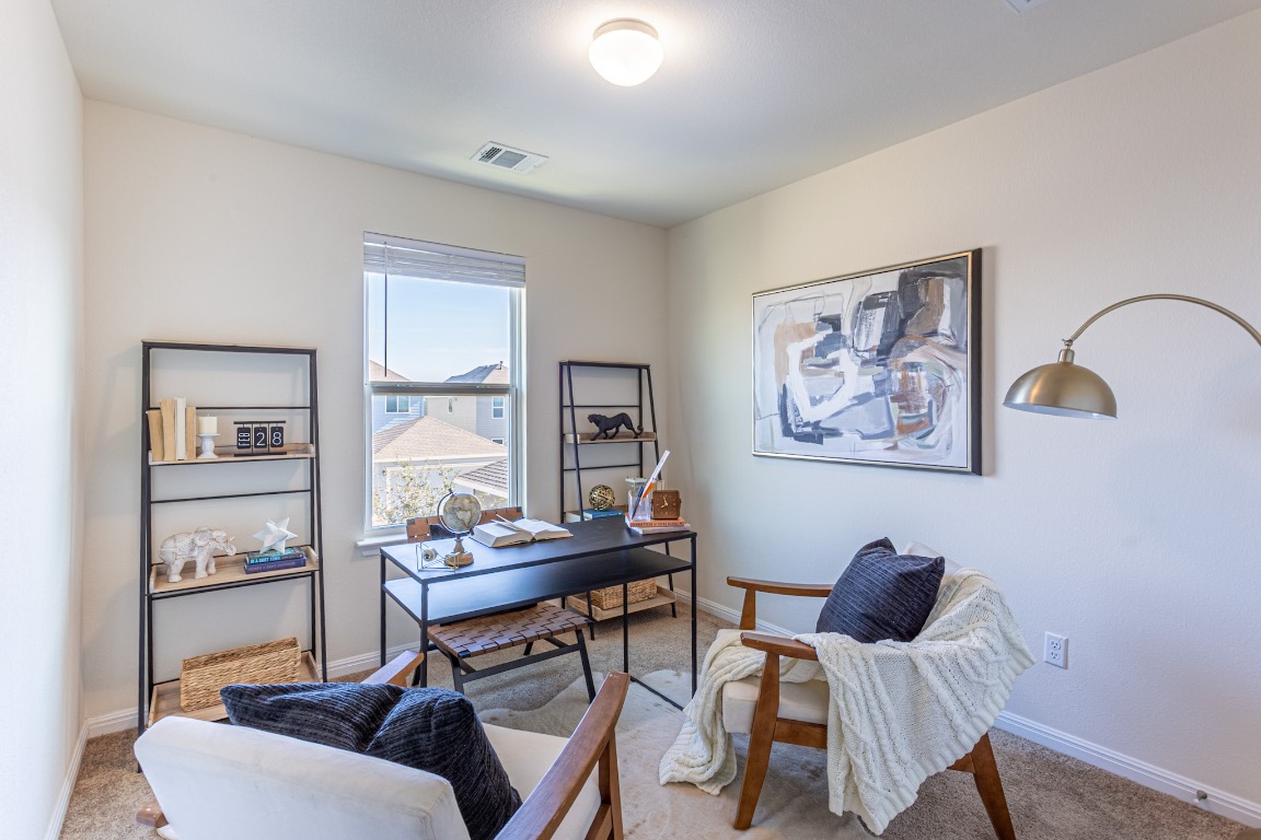17927 Papaveri Way Pflugerville, TX 78660 - Photo 3 of 26 a living room with furniture and a window