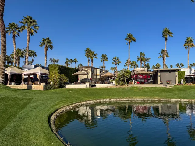 a view of a swimming pool with outdoor seating